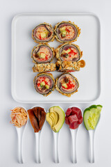 Baked sushi roll with salmon, tuna, shrimp, avocado and cream cheese