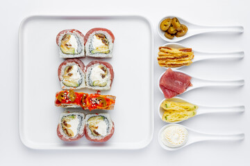 Sushi roll with tuna, avocado and Philadelphia cheese isolated on white background