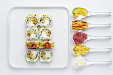 Sushi roll with tuna, avocado and Philadelphia cheese isolated on white background