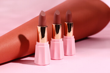 Beautiful brown lipsticks on colorful background