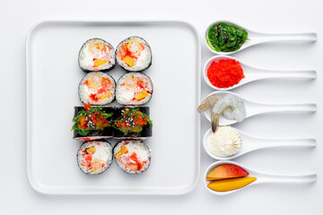 Sushi roll with shrimp, mango and cream cheese on a white background isolated