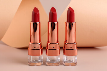 Beautiful red lipsticks on beige background