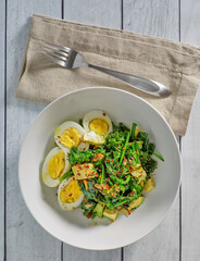 power bowl made of sauteed spinach, hard boiled eggs, and diced avocado