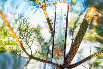 Thermometer on winter snow background. Thermometer for measuring outdoor air temperature. Cold...