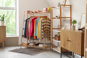 Interior of living room with clothes rack and shelf unit