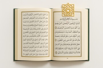 Obraz premium Open Book with Arabic Religious Text and Decorative Bookmark: Islamic Literature and Spiritual Study in Diagonal Flat Lay Composition