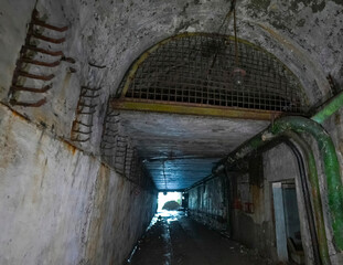 equipment, wiring and pipes in an abandoned underground
