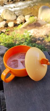 cup of iced chocolate drink outdoor by the river