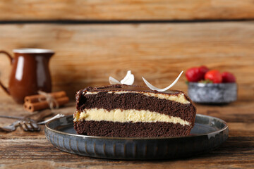 Plate with pieces of sweet chocolate cake on wooden background
