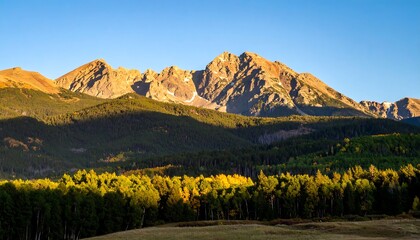 Fototapeta premium Mountain range at dawn with fall foliage