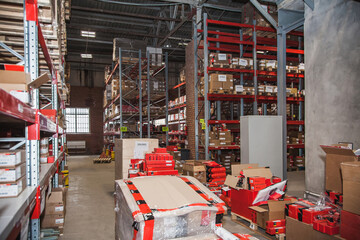 Storage area in a busy warehouse showcasing shelves filled with various products and items