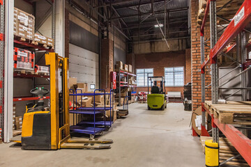 Warehouse interior with forklifts and storage racks during daytime in a commercial space
