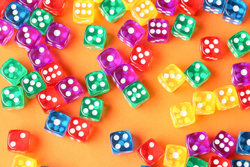 Colorful game dices on orange background