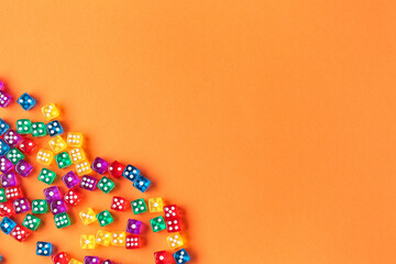 Colorful game dices on orange background