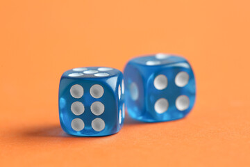 Blue game dices on orange background