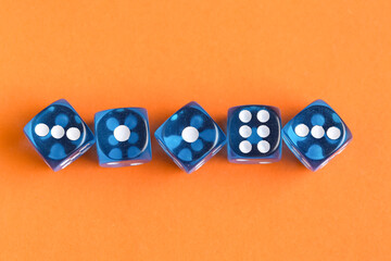 Blue game dices on orange background
