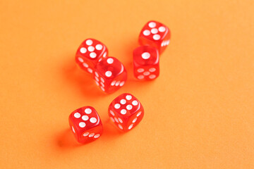 Red game dices on orange background