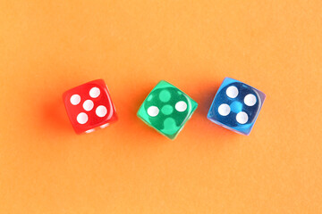 Different game dices on orange background