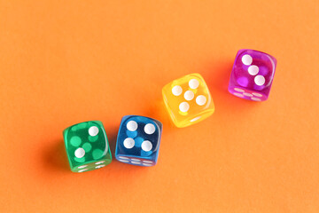 Different game dices on orange background