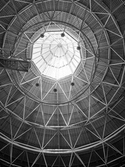 Abstract geometric structure with radiating lines converging towards a bright center, creating a starburst effect.