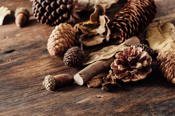 Natural Elements on Wooden Background with Pinecones and Leaves