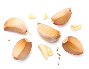 Overhead view of whole and sliced garlic bulbs on white background