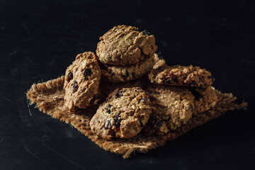 Freshly Baked Oatmeal Cookies with Chocolate Chips on Rustic Cloth