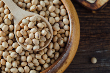 Organic Soybeans in Wooden Bowl with Wooden Spoon on Rustic Table