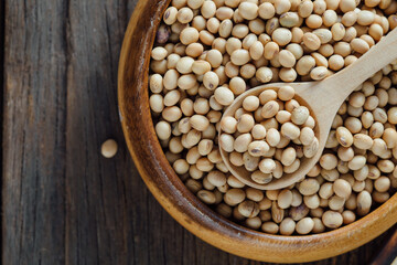 Soybeans in Wooden Bowl with Wooden Spoon on Rustic Background
