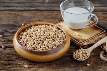 Fresh Soybeans in Wooden Bowl with Glass of Soy Milk on Table