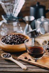 Fresh Brewed Coffee with Beans and Brewing Equipment on Wooden Table