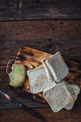 Slices of Whole Wheat Bread on Rustic Wooden Cutting Board