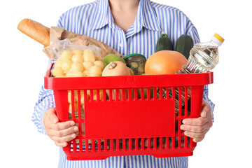 Woman holding red shopping basket with different fresh products on white background