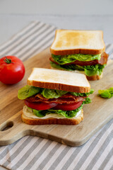 Homemade BLT (Bacon Lettuce Tomato)  Sandwich with Mayo, side view.