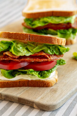 Homemade BLT (Bacon Lettuce Tomato) Sandwich with Mayo, side view. Close-up.