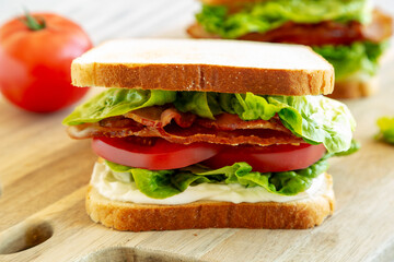 Homemade BLT (Bacon Lettuce Tomato) Sandwich with Mayo, side view. Close-up.