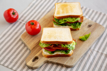 Homemade BLT (Bacon Lettuce Tomato) Sandwich with Mayo, side view.