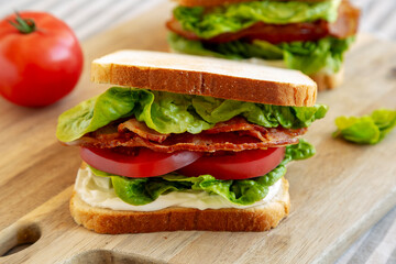 Homemade BLT (Bacon Lettuce Tomato) Sandwich with Mayo, side view. Close-up.