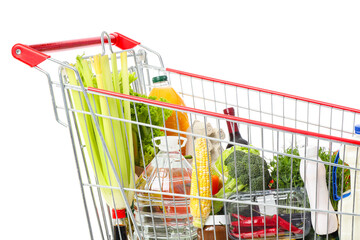 Shopping cart with different fresh products on white background, closeup