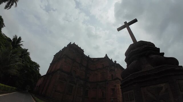 The Basilica of Bom Jesus: A Solemn Baroque Silhouette Against a Tempestuous Evening Sky, Embodying the Enduring Cross and the Dark Mystique of Old Goa, India