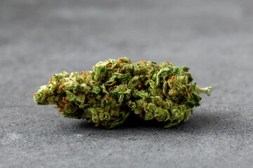 Close-Up View of Green Cannabis Bud on Gray Background