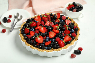 Sweet tart with different fresh berries on white background, closeup