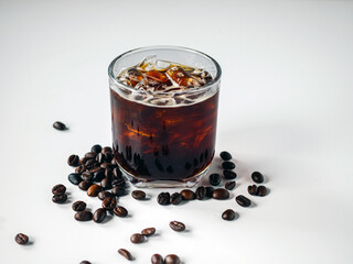 Iced black coffee, iced Americano coffee in glass and roasted coffee beans on white background.