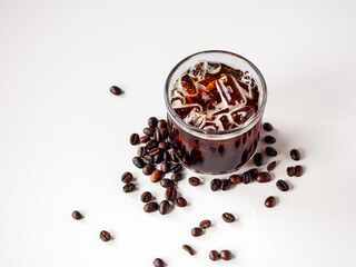 Iced black coffee, iced Americano coffee in glass and roasted coffee beans on white background. top view