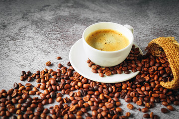 Coffee cup and coffee beans in sack on gray background, Espresso crema coffee cup aromatic