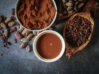 Top view of Cocoa drink, Natural cocoa powder with brown cocoa beans and cacao pod on a gray background