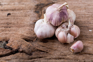 Fresh Garlic Bulbs on Rustic Wooden Surface with Natural Texture