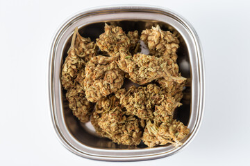 High-Quality Dry Cannabis Buds in Metal Container on White Background
