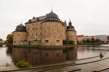 Fototapeta premium OREBRO, SWEDEN - 2 October 2022: The castle of Orebro is a medieval stone building, which is one of the most famous and historically significant castles of the Kingdom of Sweden in autumn