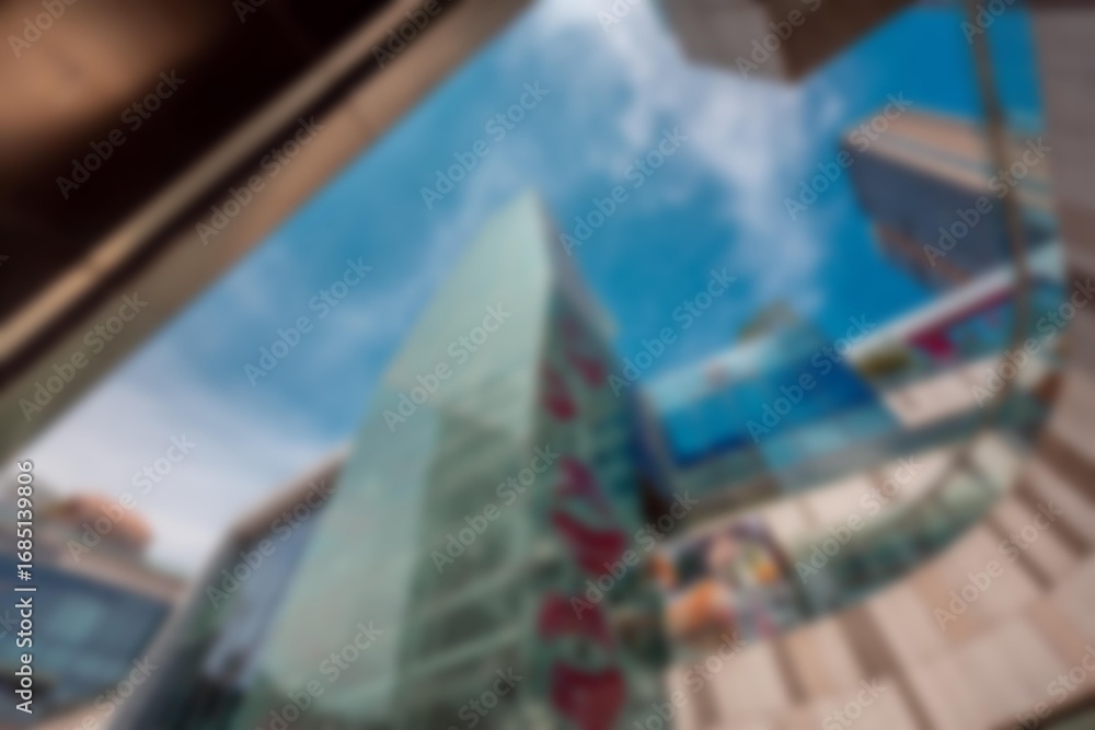 Poster an abstract view of a shopping mall from within a building with blue sky and white clouds in the bac